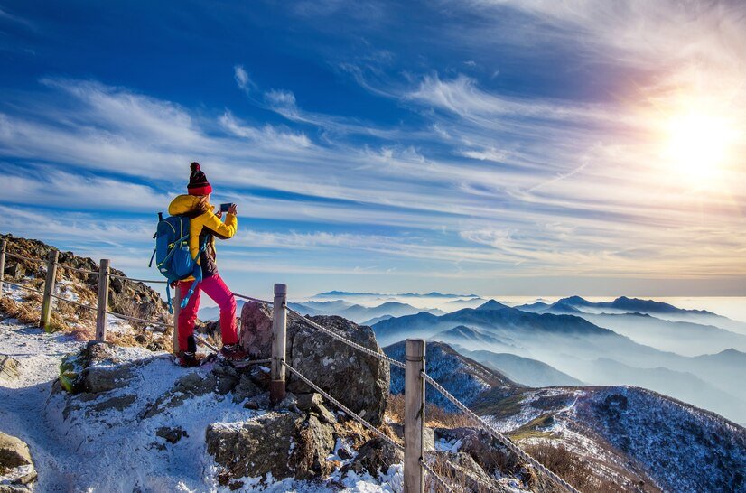 young-woman-hiker-taking-photo-with-smartphone-mountains-peak-winter_335224-427.jpg